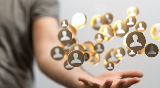 istock Icons of people linked together hovering above mans hand 1447595048