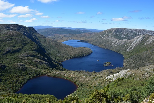 A river surrounded by the beautiful Cradle Mountain on a sunny day