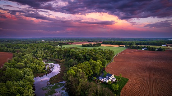 An aerial view of rainbow sunset in the countryside of Cranbury in New Jersey, USA