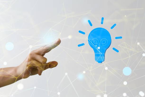 istock Hand pointing to a 3D rendered light bulb hologram in cyberspace  in the air 1447595724