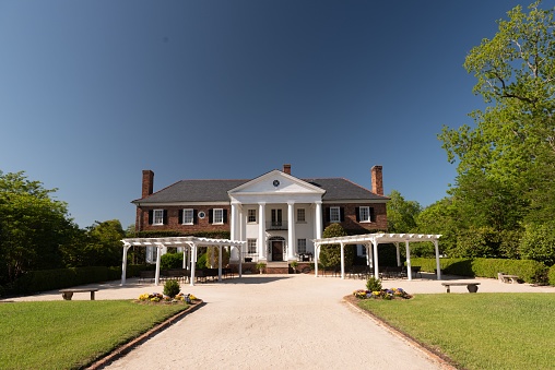 Charleston, United States – May 02, 2018: A southern style house at the Boone Hall Plantation with a beautiful green garden