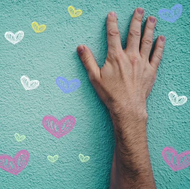 istock Hand on the blue wall with heart illustrations 1447595775