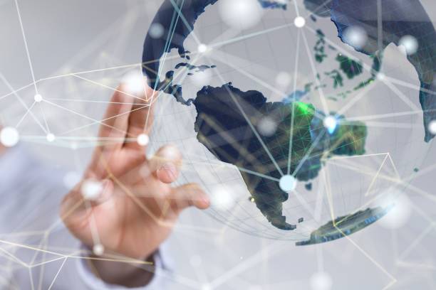 istock 3D rendering of connecting lines and dots with a globe in the background and a man pointing at it 1447595840
