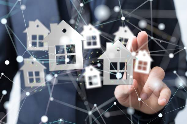 istock 3D rendering of small houses with a man in a background pointing at it 1447595852