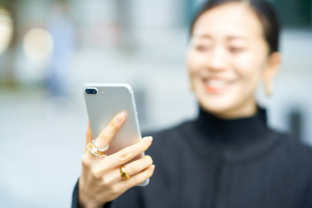 istock Woman looking at smartphone screen 1447596395