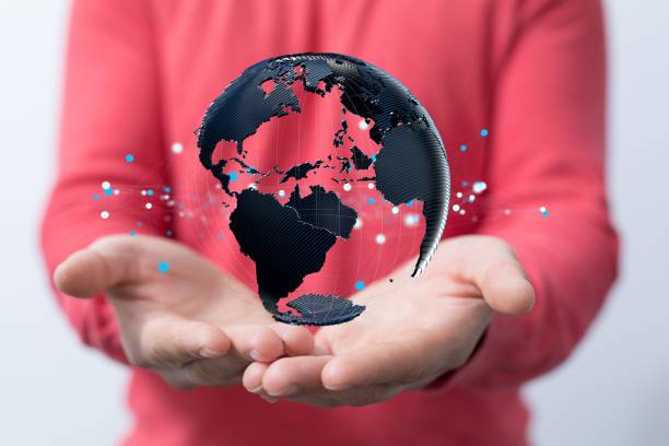 istock Person holding a 3D rendering of the globe in his hands. 1447596483