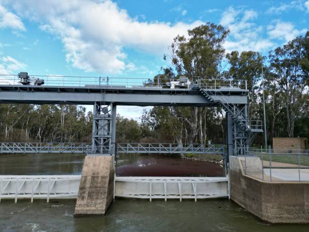 istock Low head dam on a river in the park 1447596532
