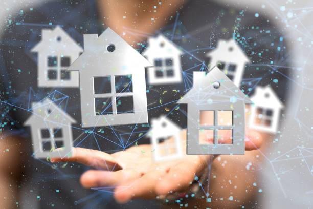 istock Man demonstrating with his hand silver houses with big windows located in network space 1447596534