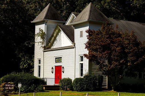 The Campbellton United Methodist Church on grassland with trees in Fairburn town, Georgia