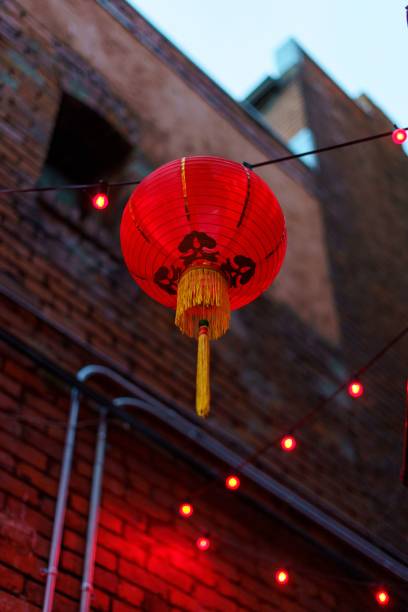 istock Vertical low angle shot of a red Chinese lantern hanging on a pole 1447599580