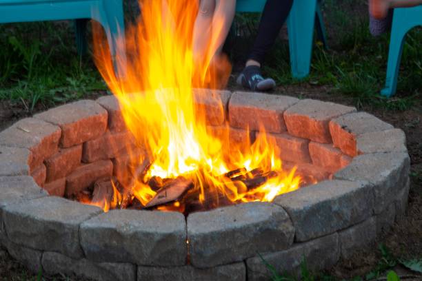 istock Closeup shot of fire burning in a stone brick pit in a park 1447599885