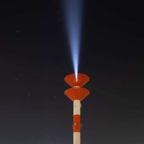 istock Low angle shot of a thin lighthouse against a starry sky at nighttime 1447600192