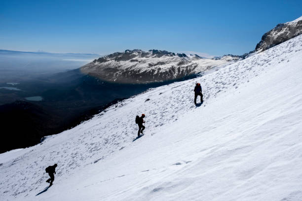 istock mountaineers climb to the summit together on a difficult and steep slope 1447601959