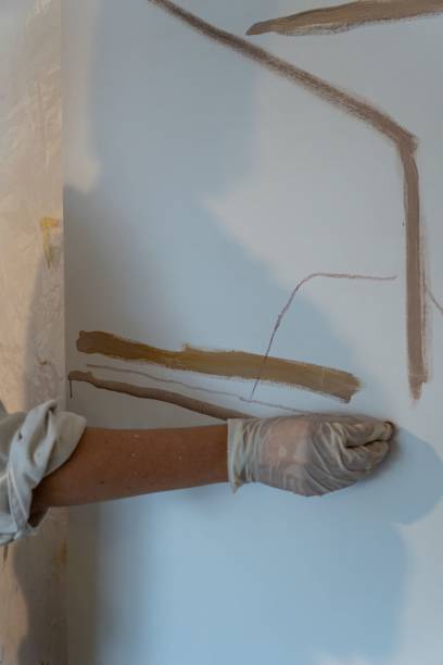 istock Vertical shot of a hand drawing with the brown paint on a white canvas 1447603476