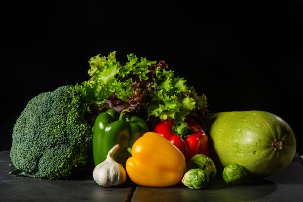 istock Healthy fresh vegetables on the black background 1447604140