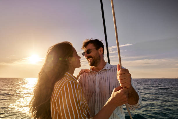 istock Happy couple talking on a boat at sunset. 1447604847