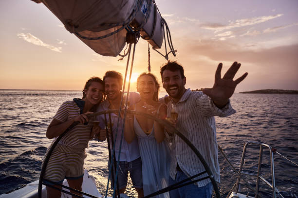 istock Young happy friends having fun on a boat at sunset. 1447606698