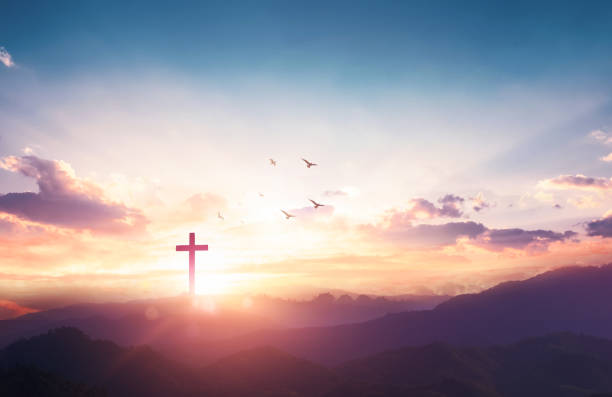 Christian wooden cross on sunset background. stock photo