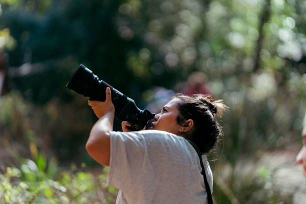 istock Female photographer in a dense forest 1447609070