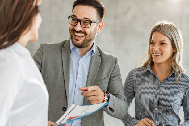 istock Happy business colleagues talking about reports in the office. 1447609469