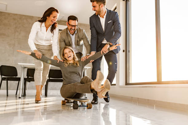 istock Playful business people having fun in the office. 1447609944
