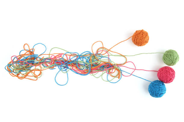 istock Tangled colorful cotton threads and balls isolated on white background. 1447612081