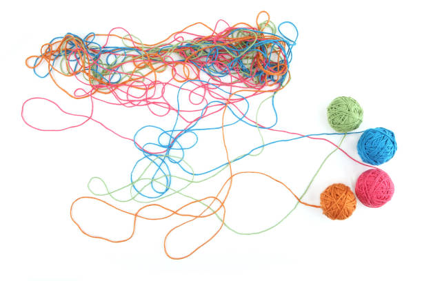 istock Tangled colorful cotton threads and balls isolated on white background. 1447612094