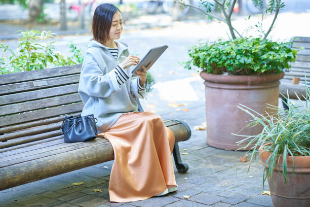 istock A woman in casual clothes operating a tablet PC 1447616378