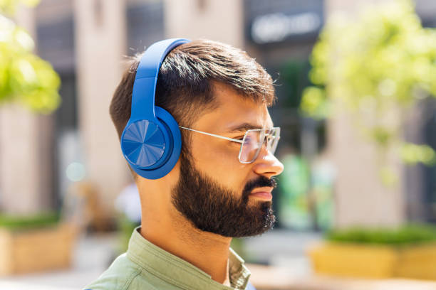 istock indian student with blue headset and backpack well looking at sunny day 1447616569