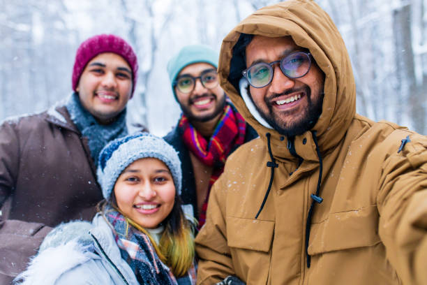 istock four people taking selfie shot outdoors at new year holidays 1447616762