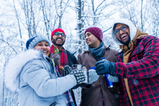 istock Happy young indian friends get warming with hot tea 1447616776