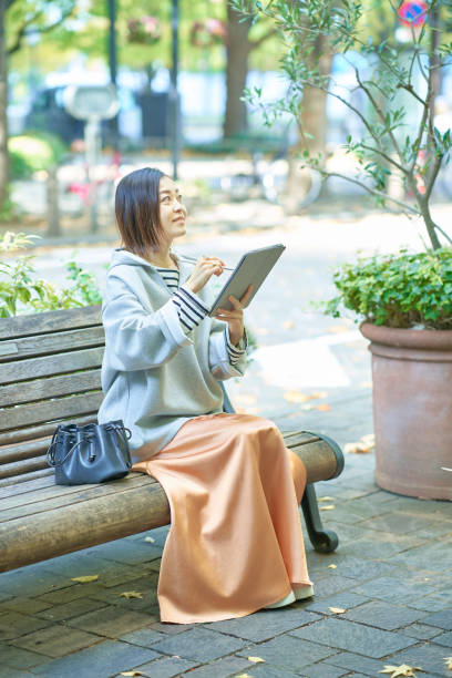 istock A woman in casual clothes operating a tablet PC 1447616929