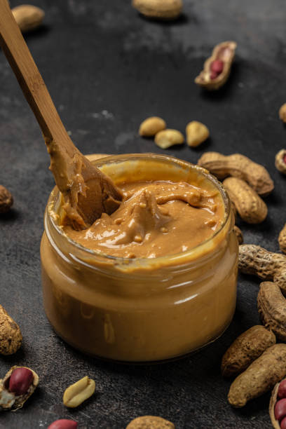 istock peanut butter and peanut beans. vertical image. top view. place for text 1447620175