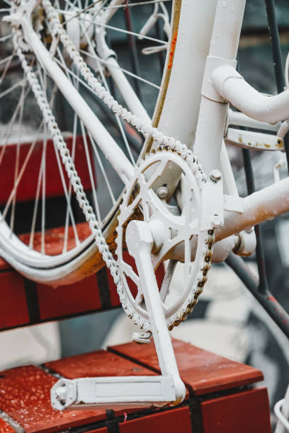 istock White painted vintage bicycle chain and pedal, close-up 1447620611