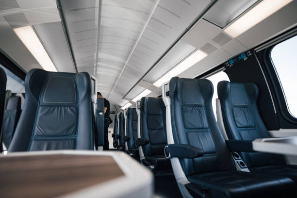 istock Passenger is standing amidst empty seats. Interior of modern illuminated subway or intercity train. Concept of rail transportation. 1447621723