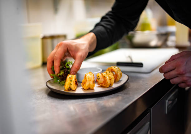 istock man chef cooking tasty shrimp on kitchen 1447622122