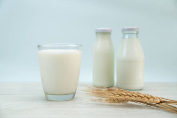 istock Glass of milk on blue background 1447622402