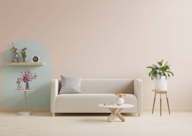 istock Living room with sofa and accessories decoration on empty cream color wall background. 1447622465