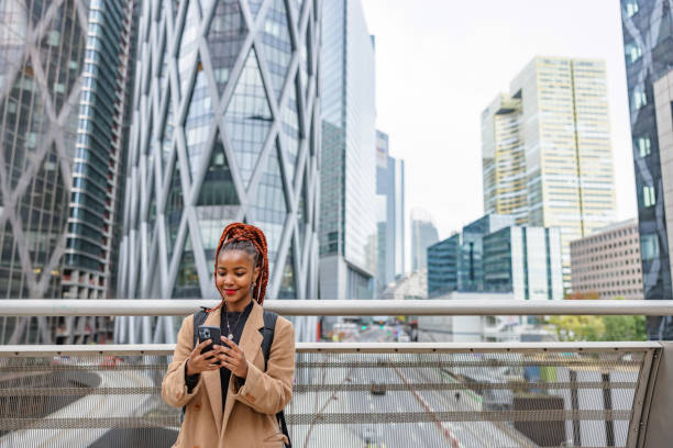 istock African Lady Standing On A Bridge Overlooking The Financial District 1447623208