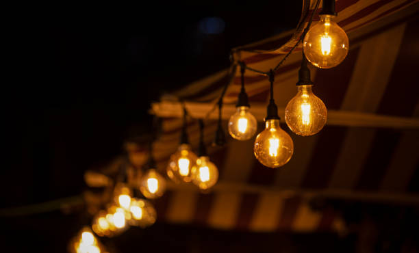 istock Light bulbs on street at night 1447623939