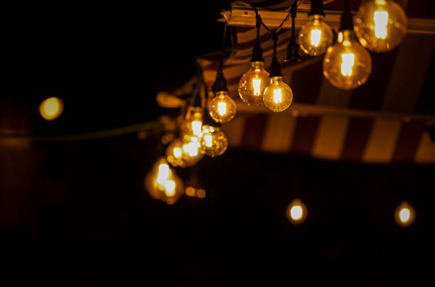 istock Light bulbs on street at night 1447623943