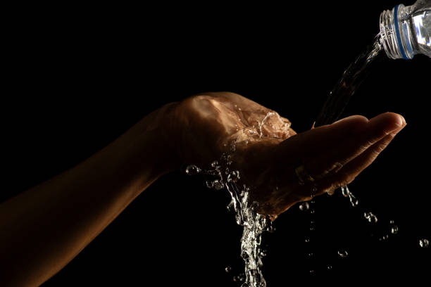 istock Water splashing on hand water captured at high speed slow motion showing unique patterns and textures 1447624102
