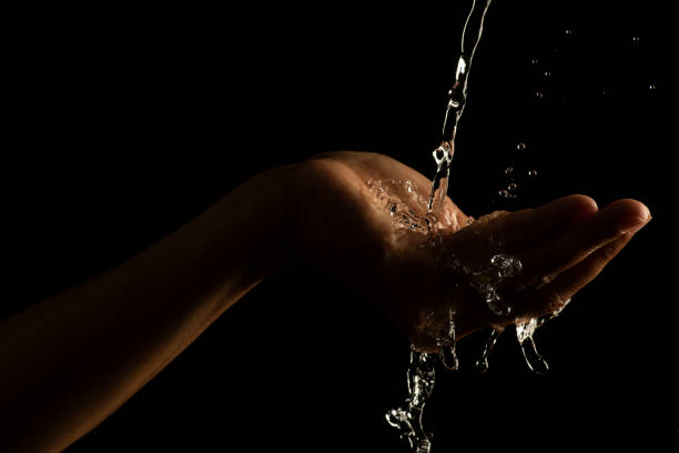 istock Water splashing on hand water captured at high speed slow motion showing unique patterns and textures 1447624103