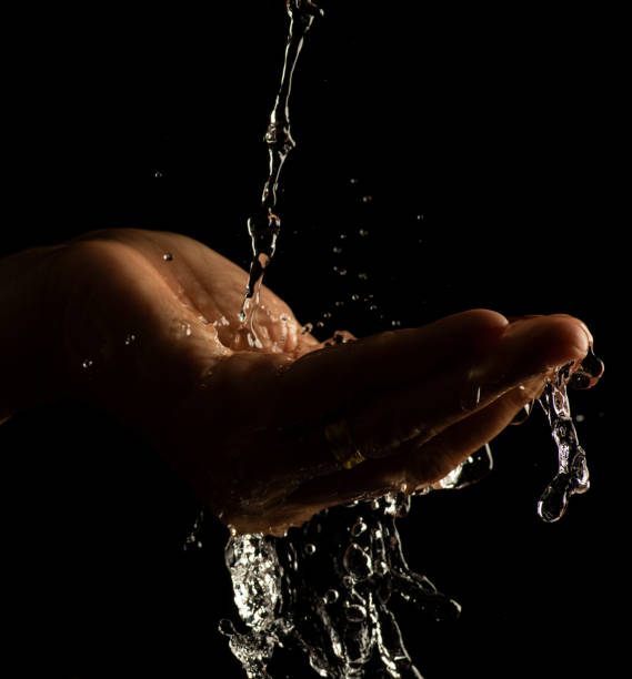 istock Water splashing on hand water captured at high speed slow motion showing unique patterns and textures 1447624143
