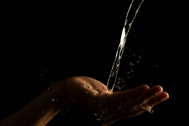 istock Water splashing on hand water captured at high speed slow motion showing unique patterns and textures 1447624145