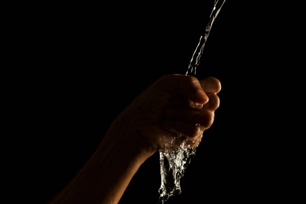 istock Water splashing on hand water captured at high speed slow motion showing unique patterns and textures 1447624704