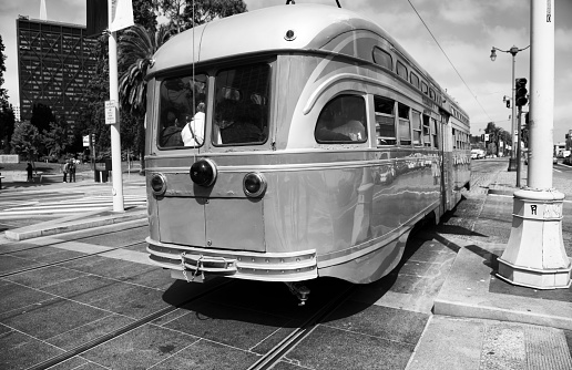 Lisbon, Portugal - December 9, 2023: A traditional lisbon tram runs along the Praça do Comércio square in Lisbon downtown.
