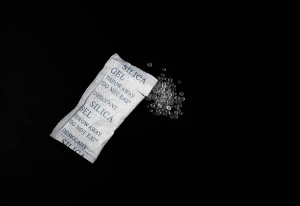 istock Desiccant Silica Gel Adsorbent Crystals on Black Background, Desiccant Polymer Balls 1447628215