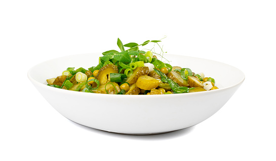 Pickled Gherkins Salad in White Bowl. Chopped Pickled Cucumbers, Canned Green Peas, Green Onions Salat Isolated on White Background Side View