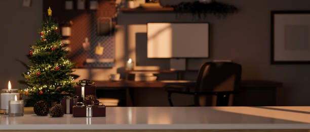 istock Copy space on tabletop with Christmas tree, gift boxes and candles over blurred home workstation 1447628404